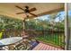 Enjoy outdoor living on this wood porch with a ceiling fan, table and chairs, and a view of the landscape at 5908 Mohr Rd, Tampa, FL 33615