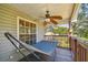 Relaxing covered porch with a hammock, ceiling fan, and scenic views at 5908 Mohr Rd, Tampa, FL 33615