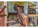 Exterior wooden staircase leading to an elevated porch with wooden railings at 5908 Mohr Rd, Tampa, FL 33615
