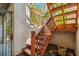Wooden staircase leading to the upper level, complemented by a decorative fountain at 5908 Mohr Rd, Tampa, FL 33615