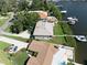 Impressive aerial view features waterfront property with boat dock, pool, and well-manicured grounds at 6663 Bayou Grande Ne Blvd, St Petersburg, FL 33702