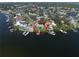 Aerial view showing this home has its own private dock, water access, and lush landscaping at 6663 Bayou Grande Ne Blvd, St Petersburg, FL 33702