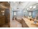 Bathroom with a walk-in shower, bathtub, and double sink vanity with granite countertops at 6663 Bayou Grande Ne Blvd, St Petersburg, FL 33702