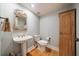 This powder room includes beautiful shell mirror and decorative hardware at 6663 Bayou Grande Ne Blvd, St Petersburg, FL 33702