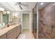 Bathroom with a walk-in shower, bathtub, and double sink vanity with granite countertops at 6663 Bayou Grande Ne Blvd, St Petersburg, FL 33702