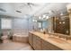 Bathroom with a walk-in shower, bathtub, and double sink vanity with granite countertops at 6663 Bayou Grande Ne Blvd, St Petersburg, FL 33702