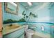 Whimsical bathroom features a hand painted mural, shell-framed mirror, and unique coastal accents at 6663 Bayou Grande Ne Blvd, St Petersburg, FL 33702