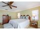 Bedroom with a ceiling fan, two bedside tables with lamps, and white walls at 6663 Bayou Grande Ne Blvd, St Petersburg, FL 33702