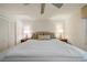 Bedroom with a ceiling fan, two bedside tables with lamps, and white walls at 6663 Bayou Grande Ne Blvd, St Petersburg, FL 33702
