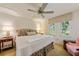 Cozy bedroom featuring two windows, a ceiling fan, and bedside tables with lamps at 6663 Bayou Grande Ne Blvd, St Petersburg, FL 33702