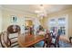 Formal dining room with a chandelier, table that seats eight, and doors leading to a balcony at 6663 Bayou Grande Ne Blvd, St Petersburg, FL 33702