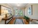 Elegant entryway with wood floors, a console table, decorative rug and a view of the outdoors through the double doors at 6663 Bayou Grande Ne Blvd, St Petersburg, FL 33702