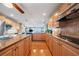 Spacious kitchen with granite countertops, wood cabinets, stainless appliances, and an island at 6663 Bayou Grande Ne Blvd, St Petersburg, FL 33702