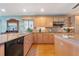 Well-equipped kitchen with natural wood cabinets, granite countertops, and stainless-steel appliances at 6663 Bayou Grande Ne Blvd, St Petersburg, FL 33702