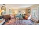 Bright living room featuring a comfortable sofa, armchairs, and a glass coffee table on top of an area rug at 6663 Bayou Grande Ne Blvd, St Petersburg, FL 33702