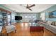 This light-filled living room has French doors, TV, hardwood floors and a ceiling fan at 6663 Bayou Grande Ne Blvd, St Petersburg, FL 33702