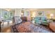 Bright living room featuring a comfortable sofa, armchairs, and a glass coffee table on top of an area rug at 6663 Bayou Grande Ne Blvd, St Petersburg, FL 33702