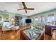 Light filled living room boasts wood floors, a ceiling fan, and French doors at 6663 Bayou Grande Ne Blvd, St Petersburg, FL 33702