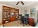 Office space with built-in wooden bookshelves, a large desk, comfortable chair, and natural light at 6663 Bayou Grande Ne Blvd, St Petersburg, FL 33702