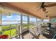 Relaxing screened porch featuring comfortable seating and panoramic water views for serene enjoyment at 6663 Bayou Grande Ne Blvd, St Petersburg, FL 33702
