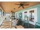 Charming screened porch with classic rocking chairs, ceiling fans, and waterfront vistas at 6663 Bayou Grande Ne Blvd, St Petersburg, FL 33702