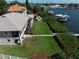 Rear exterior view of this well-maintained property, lush lawn, and waterfront access at 6663 Bayou Grande Ne Blvd, St Petersburg, FL 33702
