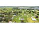 An aerial view showcasing neighborhood homes and verdant tree coverage at 6707 Josie Dr, Seffner, FL 33584