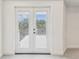Double doors with blinds lead to a balcony with scenic views from the bedroom at 6707 Josie Dr, Seffner, FL 33584