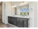 Bathroom featuring double vanity with marble countertop and large mirror under lighting fixtures at 6707 Josie Dr, Seffner, FL 33584