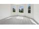 Bright bedroom featuring three arched windows with natural light and plush gray carpeting at 6707 Josie Dr, Seffner, FL 33584