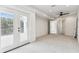 A spacious bedroom with plush carpeting, ceiling fan, and glass doors that lead to a terrace at 6707 Josie Dr, Seffner, FL 33584