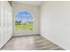 Bright bedroom featuring light wood flooring and a large window for natural light at 6707 Josie Dr, Seffner, FL 33584