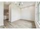 Bright dining room featuring wood-look tile floors and modern light fixture, adjacent to the kitchen area at 6707 Josie Dr, Seffner, FL 33584