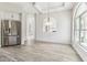 Dining room features stainless steel refrigerator and natural light from a large window at 6707 Josie Dr, Seffner, FL 33584