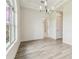 Bright dining room featuring wood-look tile floors, modern light fixture, and access to other rooms at 6707 Josie Dr, Seffner, FL 33584