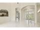 Bright foyer with high ceilings, decorative glass front doors, and beautiful tile flooring at 6707 Josie Dr, Seffner, FL 33584