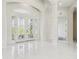 Bright foyer features marble flooring, decorative glass double-doors, and high ceilings at 6707 Josie Dr, Seffner, FL 33584
