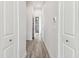 Hallway with wood-style tile flooring and white doors leading to different rooms at 6707 Josie Dr, Seffner, FL 33584
