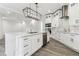 Bright kitchen features a large center island, stainless steel appliances, and wood-look floors at 6707 Josie Dr, Seffner, FL 33584