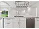 Modern kitchen island featuring stainless steel appliances, and white cabinets at 6707 Josie Dr, Seffner, FL 33584