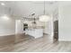 Bright kitchen features a large center island, stainless steel appliances, and wood-look floors at 6707 Josie Dr, Seffner, FL 33584