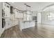 Bright kitchen features a large center island, stainless steel appliances, and wood-look floors at 6707 Josie Dr, Seffner, FL 33584