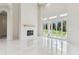 Modern living room featuring marble floors, fireplace, and large sliding doors with backyard views at 6707 Josie Dr, Seffner, FL 33584