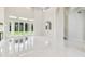 Spacious living room with marble flooring, modern fireplace, and expansive windows offering stunning outdoor views at 6707 Josie Dr, Seffner, FL 33584