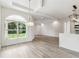 Bright living area with pendant lighting, vaulted ceiling, and arched windows with a view at 6707 Josie Dr, Seffner, FL 33584