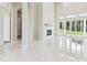 Open-concept living area features fireplace, marble floors, and large windows filling the space with natural light at 6707 Josie Dr, Seffner, FL 33584