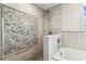 A tiled shower enclosure with a rainfall shower head and mosaic tile accent wall at 6707 Josie Dr, Seffner, FL 33584