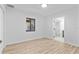 Bright bedroom features wood floors, white walls, and a glimpse into the adjacent bathroom at 711 19Th S Ave, St Petersburg, FL 33705