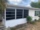 Exterior view of an enclosed porch, part of a single-story home at 7519 Kensico Dr, Port Richey, FL 34668