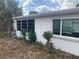 White home with palm trees and large windows offering plenty of natural light at 7519 Kensico Dr, Port Richey, FL 34668